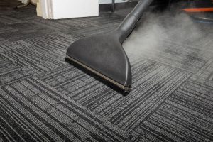 a stream cleaning vacuum being used by a commercial cleaning company in ahotel room