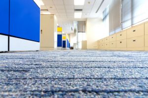the interior of an office with cabinets and blue carpet