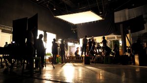A bunch of people working on a movie set.