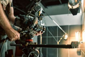 A person controlling a camera on a production set.