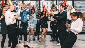 Office workers in an office holiding a party.